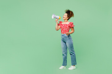 Full body young woman she wear casual clothes red blouse hold in hand megaphone scream announces discounts sale Hurry up isolated on plain pastel light green color background studio Lifestyle concept