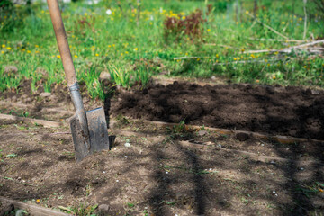 a large garden shovel in the ground. sunny day