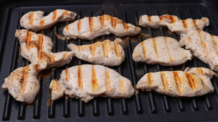 chicken breast cooked on an electric grill. Beautiful grilled chicken	