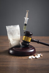 Judge gavel with a syringe, drugs, packet of heroin.