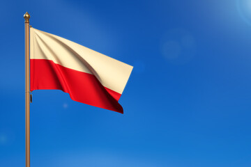 Poland. Flag blown by the wind with blue sky in the background.