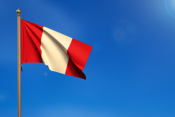Peru. Flag blown by the wind with blue sky in the background.