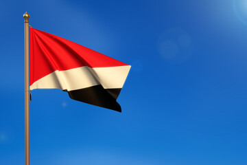 Principality of Sealand. Flag blown by the wind with blue sky in the background.
