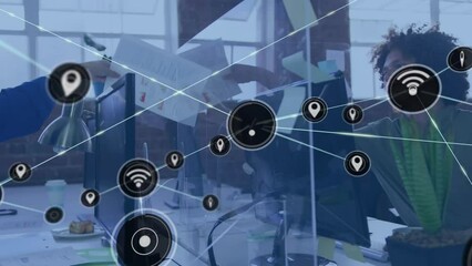Animation of network of digital icons over biracial man passing a socument to asian woman at office - Powered by Adobe
