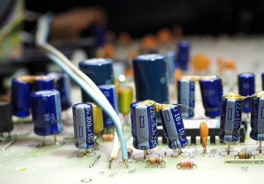 Mainly capacitors on printed circuit board. Components in industrial electronic concept.
