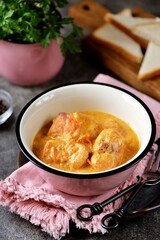 Braised rabbit back in cream with onions and carrots