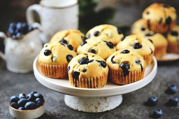 Homemade blueberry muffins with butter and milk.