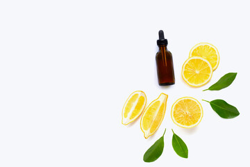 Essential oil with fresh lemon on white background.