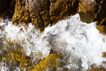 Sea water splashing on rocks