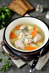 River carp soup with rice, carrots and potatoes