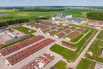 aerial panoramic view over silos and rows of barns, pigsties, chicken coops of huge agro-industrial livestock complex © hiv360