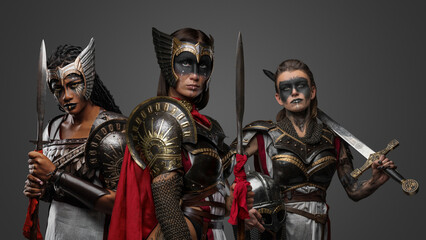 Portrait of multiracial group of female warriors from past against grey background.