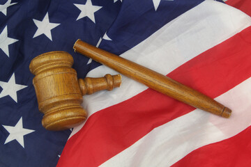 Broken gavel on US flag close up. Legal system problem and injustice in USA.