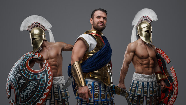 Portrait of ancient warlord fromt greece and two greek warriors with shields.