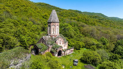 the ancient church hid in the forest in the gorge of the mountains of Armenia taken from a drone