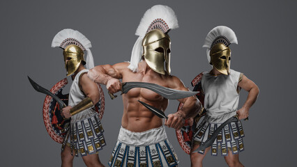 Shot of three soldiers from antique greece against grey background.
