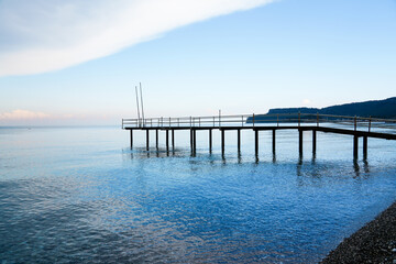 Fototapeta premium Mediterranean Sea near Kemer. Landscape in Turkey. Nature on the beach with a jetty in the background. 