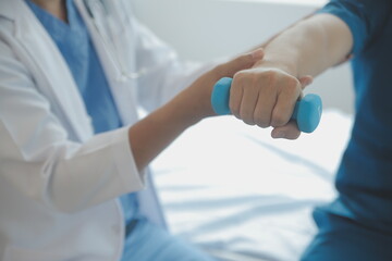 Physiotherapist working with patient in clinic, closeup