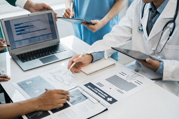 Medical team working on digital tablet healthcare doctor technology tablet using computer analyzed the results of medical reports at the hospital.