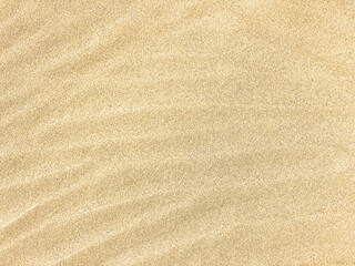 Fototapeta na wymiar Sand. Texture, surface of sea sand. Natural background. Waves of sand. Seascape. Dunes. Copy space 