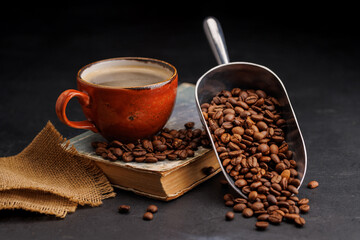 Rich coffee in a cup with aromatic roasted beans