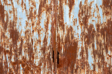 close-up view of an old rusted metal door