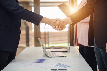 Businessman or manager handshake with young businesswoman business partners shaking hands in the office Concept of three businessman partnership