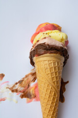 Colorful ice creams with fruit in a cone. vertical photo.