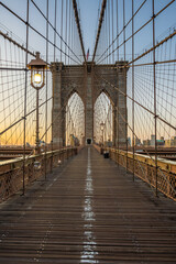 Fototapeta na wymiar The Brooklyn bridge and lighting lamps early in the morning dawn.