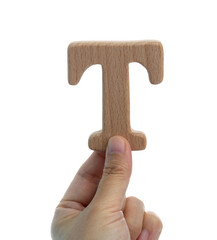 Hand holding wooden letter T