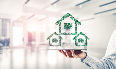 Real estate or construction idea presented by home icon on tablet pc