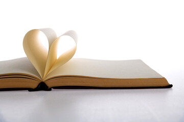 Book pages curved into heart shape