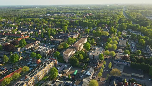 Aerial orbit of a beautiful suburban neighborhood in summer at golden hour