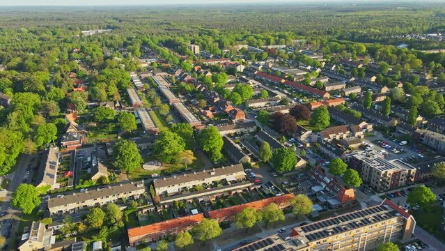 Drone flying over beautiful suburban neighborhood on a sunny summer day