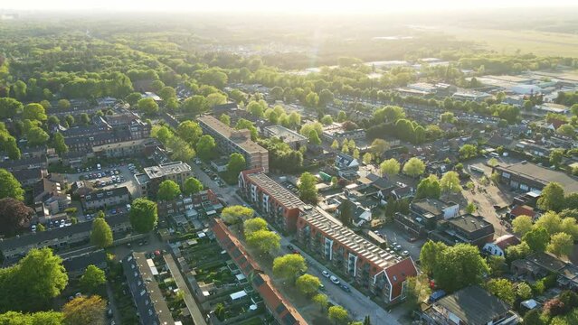 Beautiful aerial of a small town with houses with photovoltaic solar panels on rooftop at golden hour