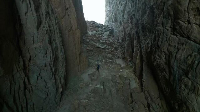 Torghatten in Norway person walking inside the hole through the mountain