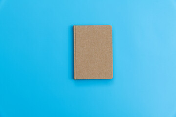 Brown book on blue background