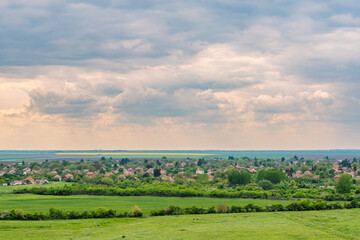 Beautiful rural landscape in Northern Bulgaria, village and agriculture field in springtime.