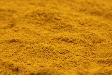 Pile of turmeric powder as background, spice or seasoning as background. Ground or sifted turmeric. Indian spice. Close up