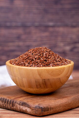Linseed on wooden background. Linseed or flax seed in wooden bowl. Close up
