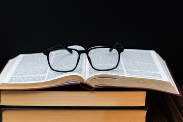 Eyeglasses on top of books