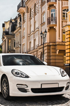 Kyiv, Ukraine - June 1, 2013: White luxury car Porsche Panamera 4S on the background of beautiful buildings