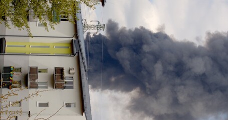 Dangerous area city wide column of black smoke rises from the roof of the house fire seat releases....