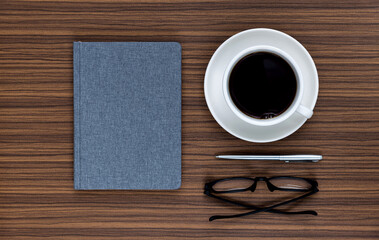 Obraz na płótnie Canvas Book with coffee cup and reading glasses