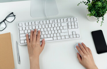 Woman hand tying on computer keyboard