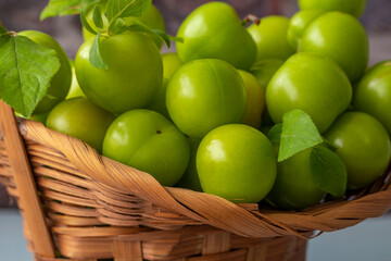 Summer fruit green plum. Fresh green plums in a basket.