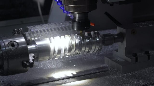 Metalworking CNC milling lathe machine for metal cutting tool processing steel metal spiral pinion or worm screw shaft in workshop. Machine for grooving into roll calibers, processing of metal parts