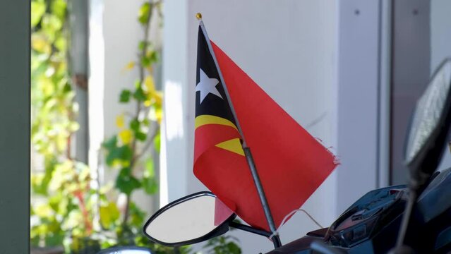 Small Timor-Leste national flag displayed on a motorbike in the capital city Dili, East Timor, Southeast Asia