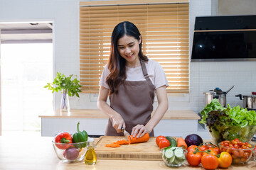Woman cutting vegetables ready for cooking.