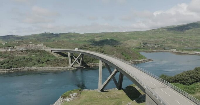 Static drone shot of motorhome driving over Kylesku Bridge along the west coast of scotland northcoast 500 route